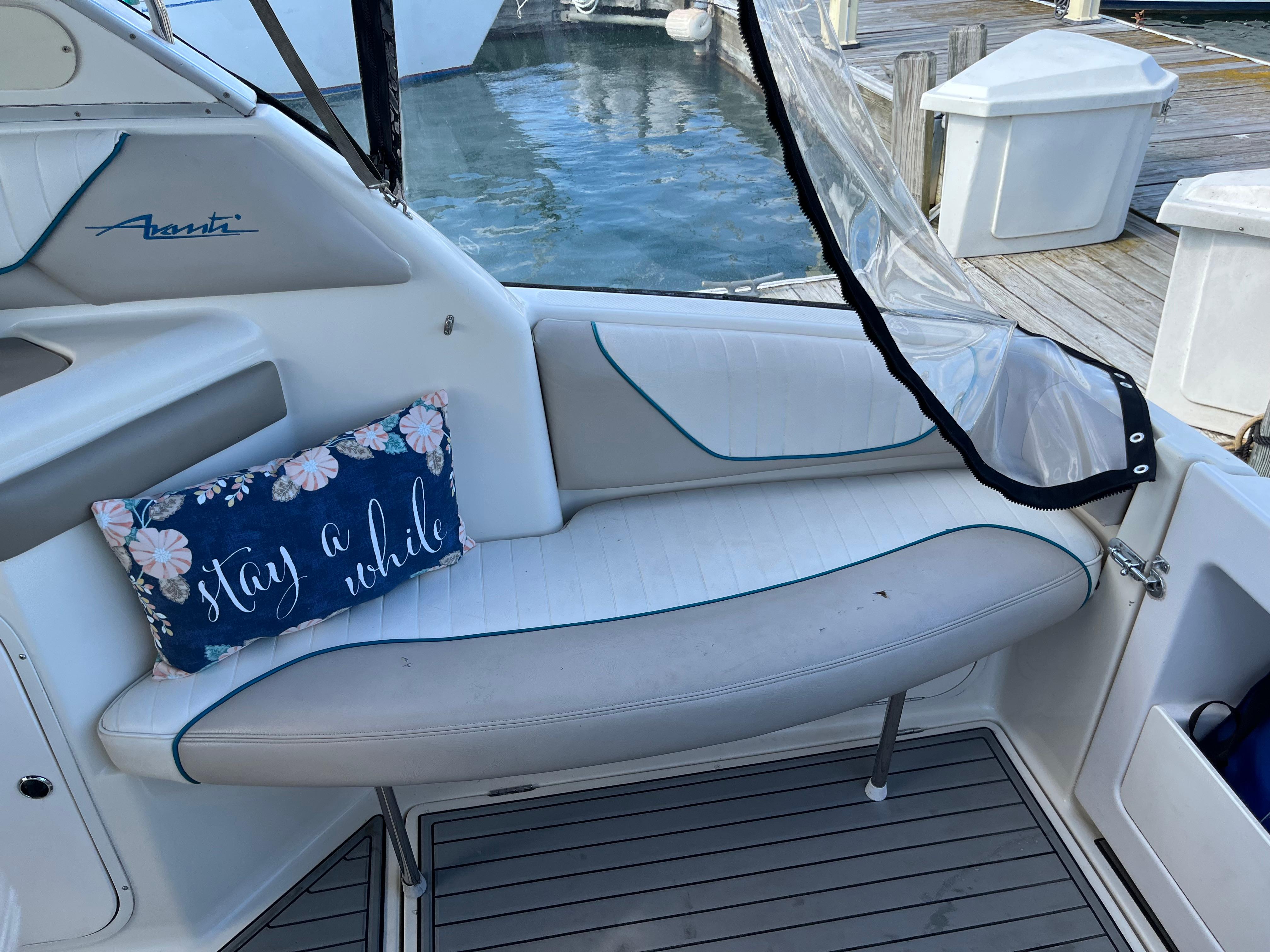 Slide: The Image of Bayliner 32 Avante 1996 boat interior with cushioned seating and Stay a while pillow. - 18