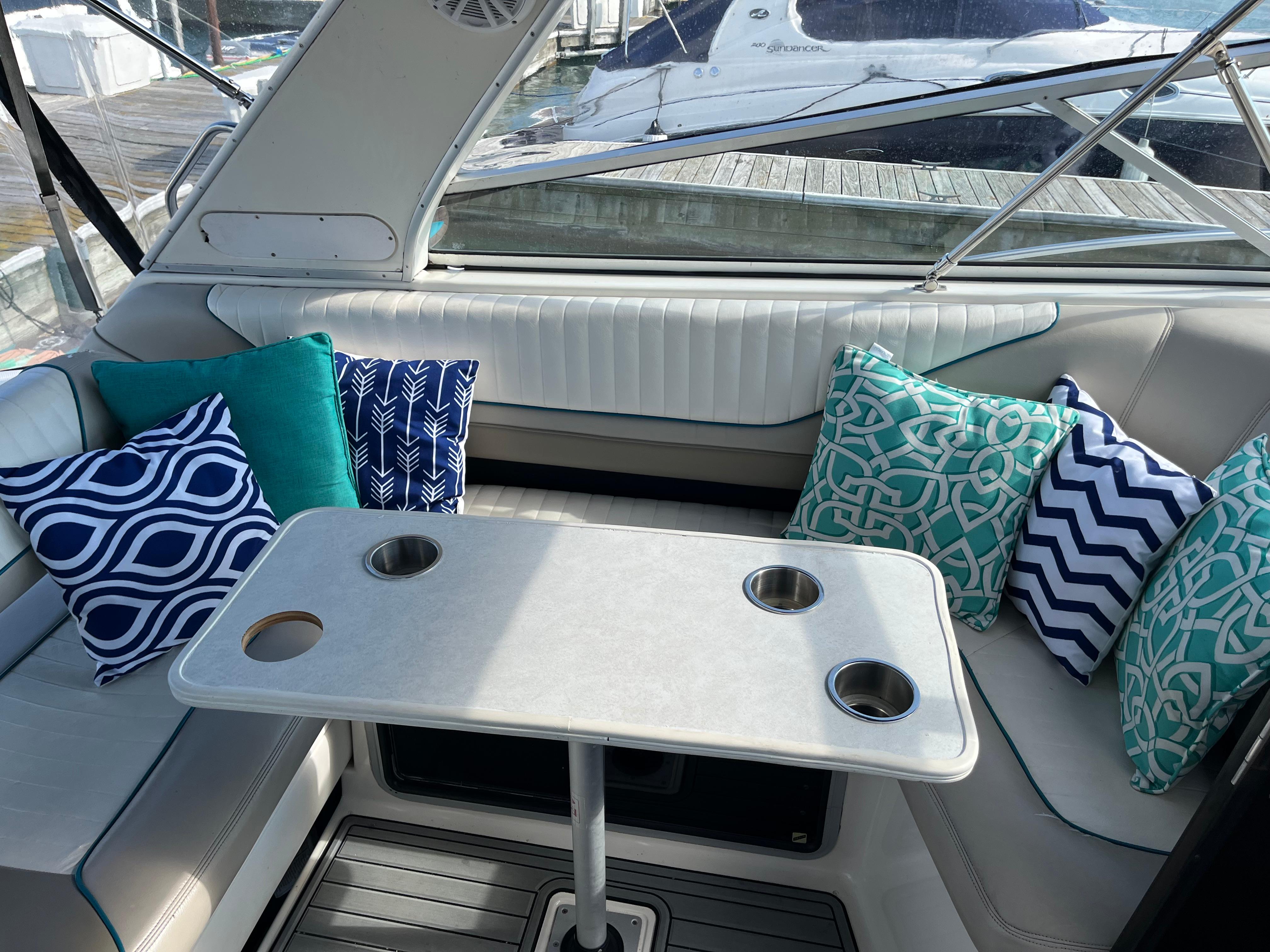 Slide: The Image of Interior of a 1996 Bayliner 32 Avante with colorful cushions and a table. - 2