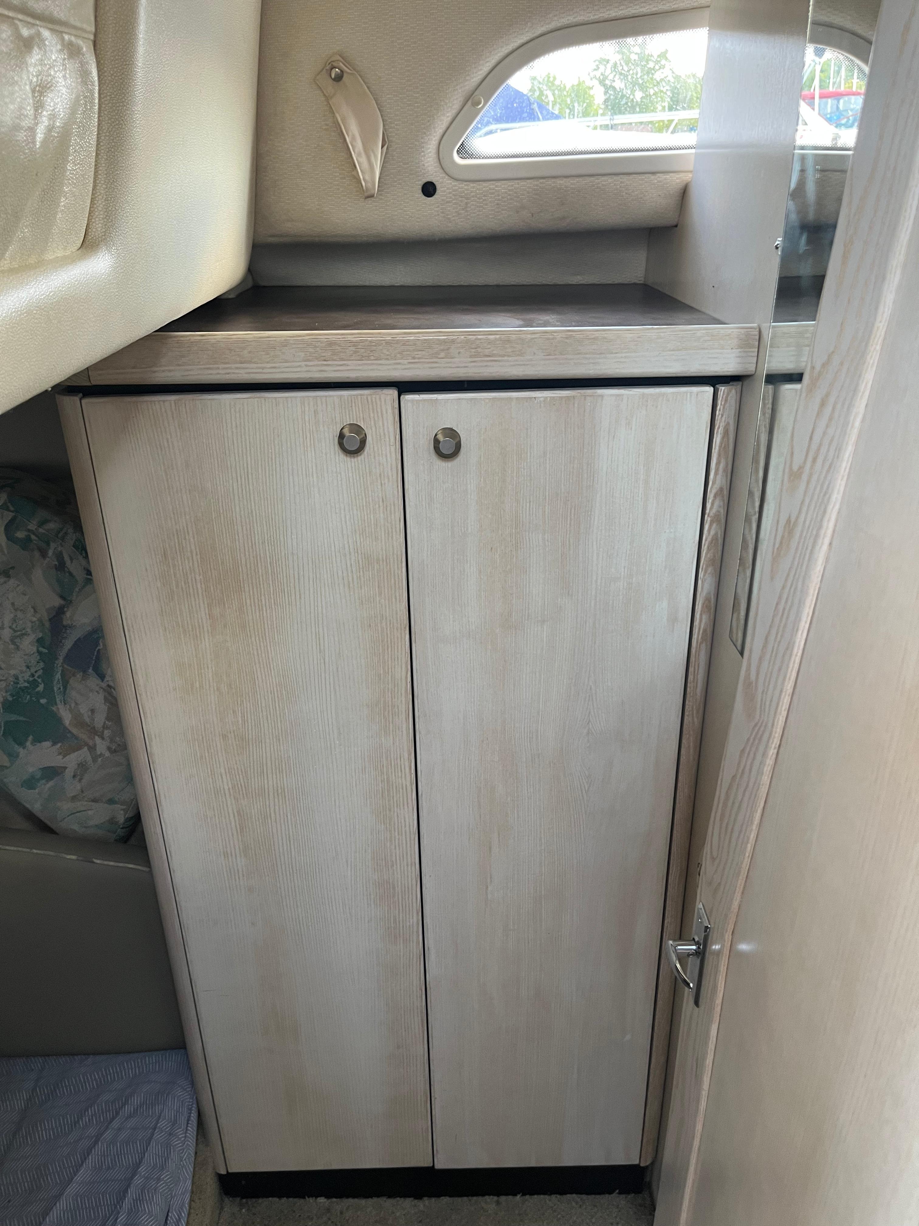 Slide: The Image of Cabinet inside 1996 Bayliner 32 Avante boat with light wood finish. - 26