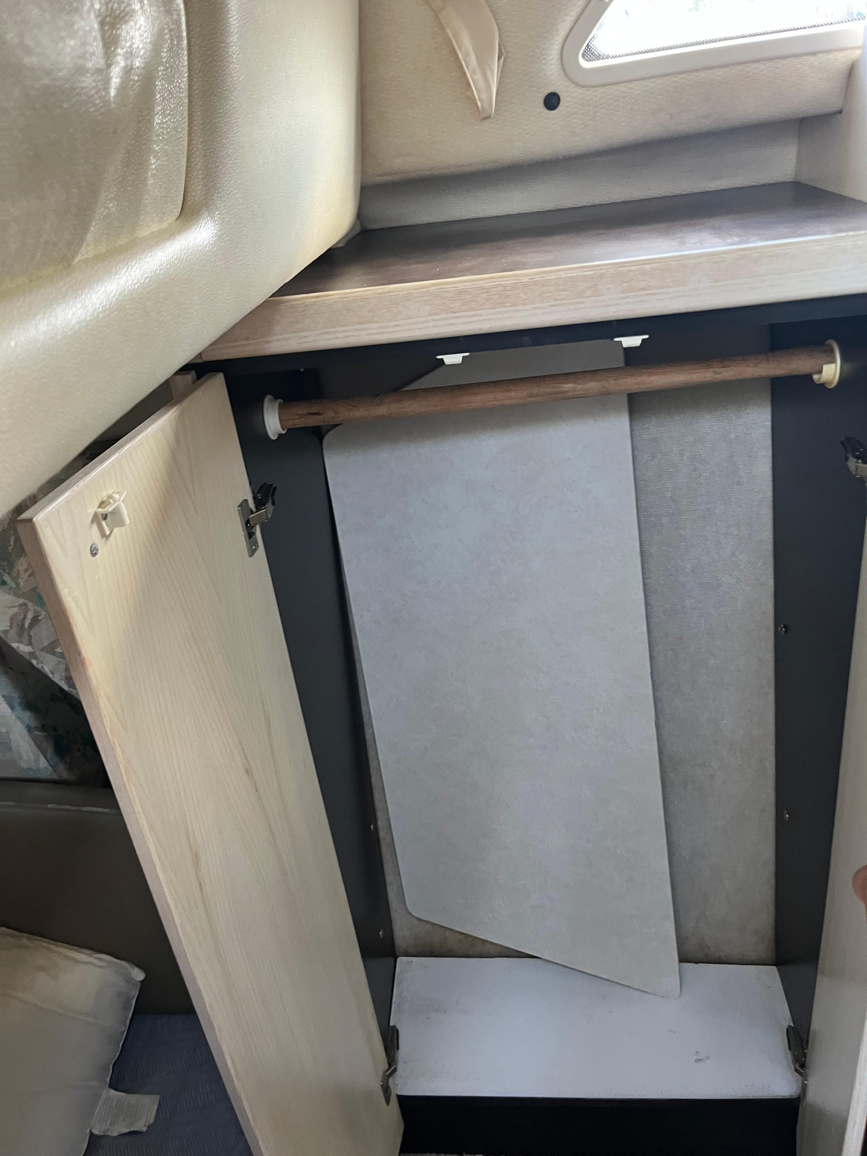 Slide: The Image of 1996 Bayliner 32 Avante interior closet with wooden rod and open doors. - 27