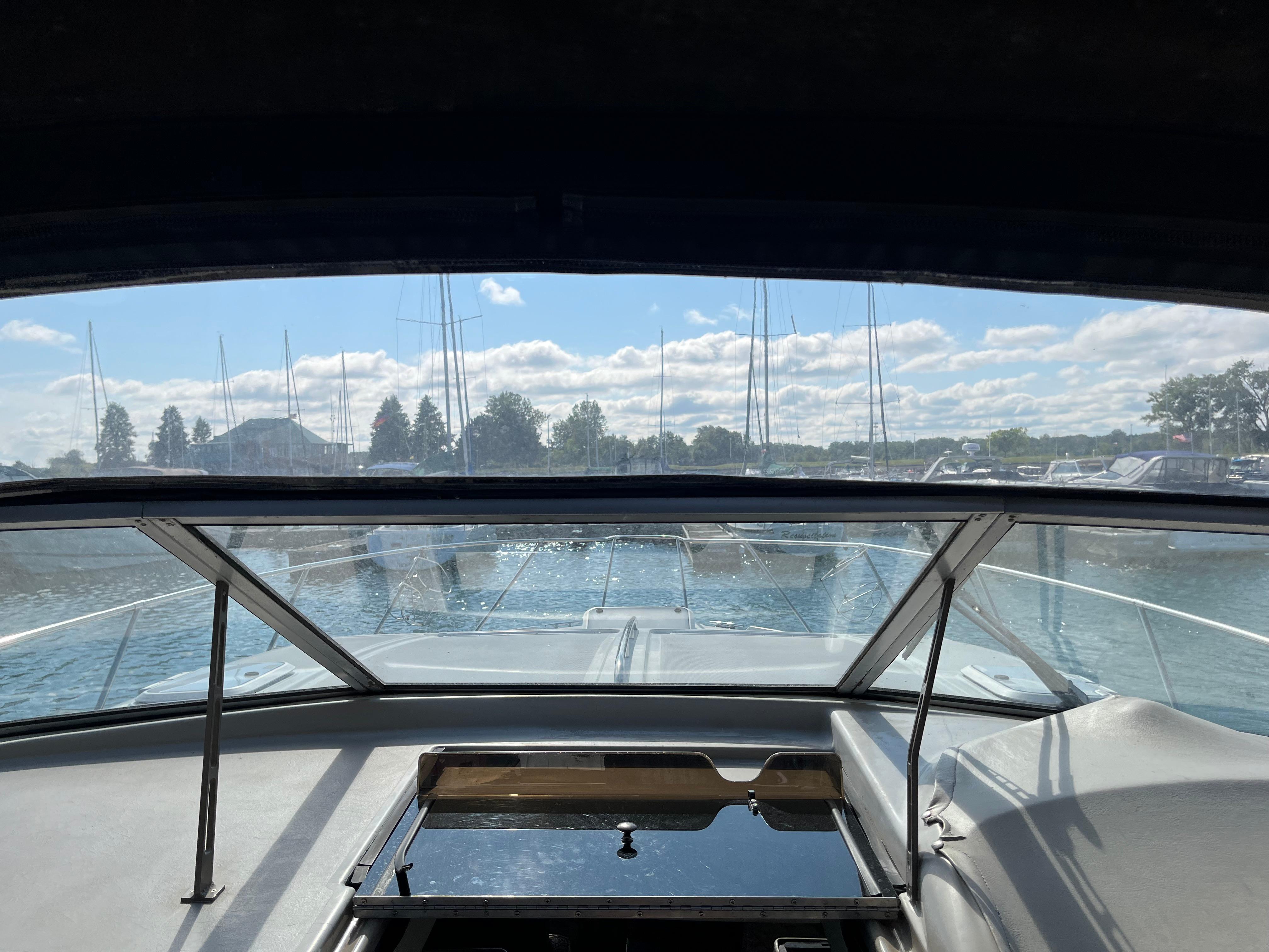 Slide: The Image of View from the cockpit of a 1996 Bayliner 32 Avante boat in a marina. - 3