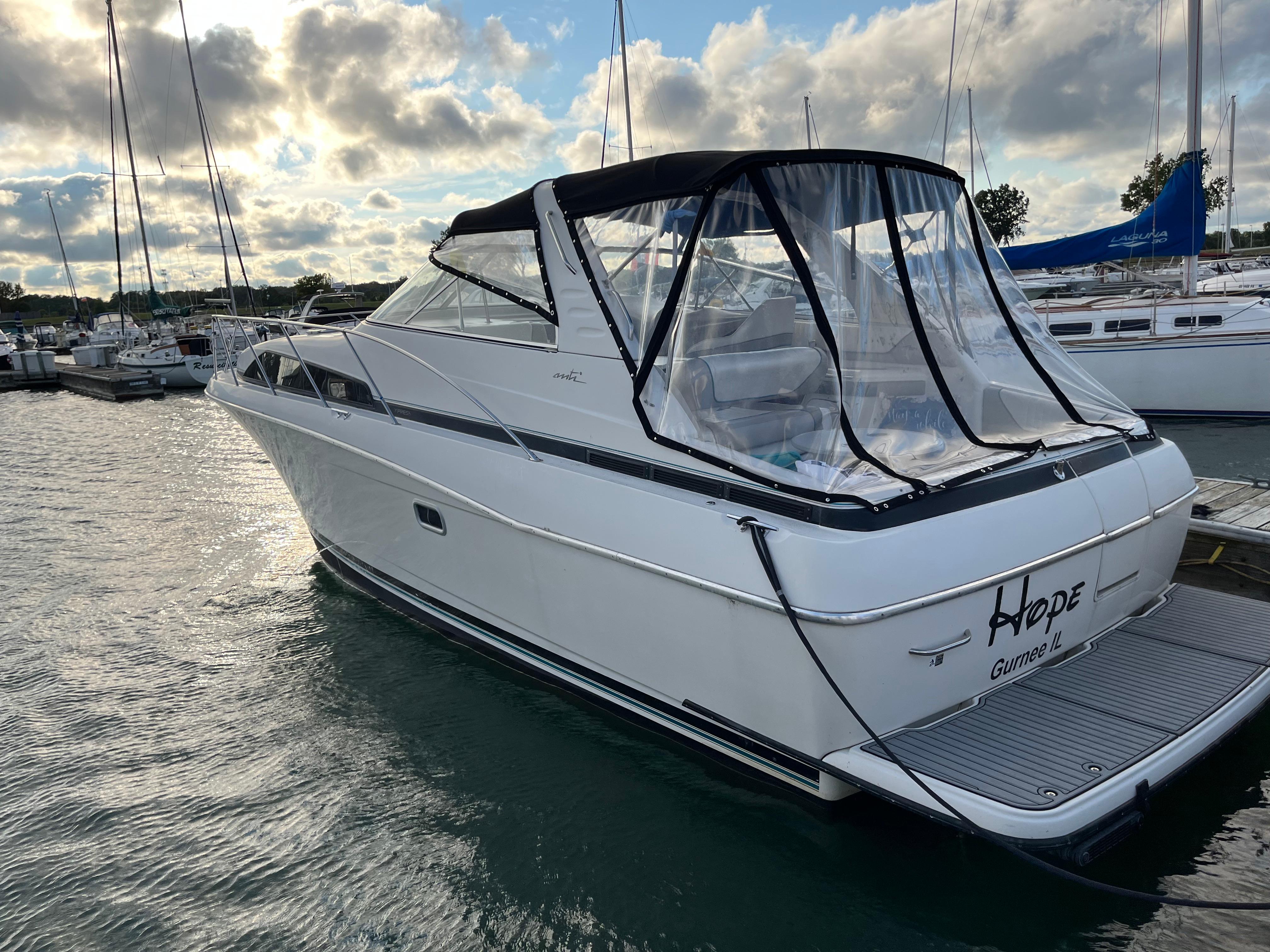 Slide: The Image of 1996 Bayliner 32 Avante boat docked at marina under cloudy sky. - 35