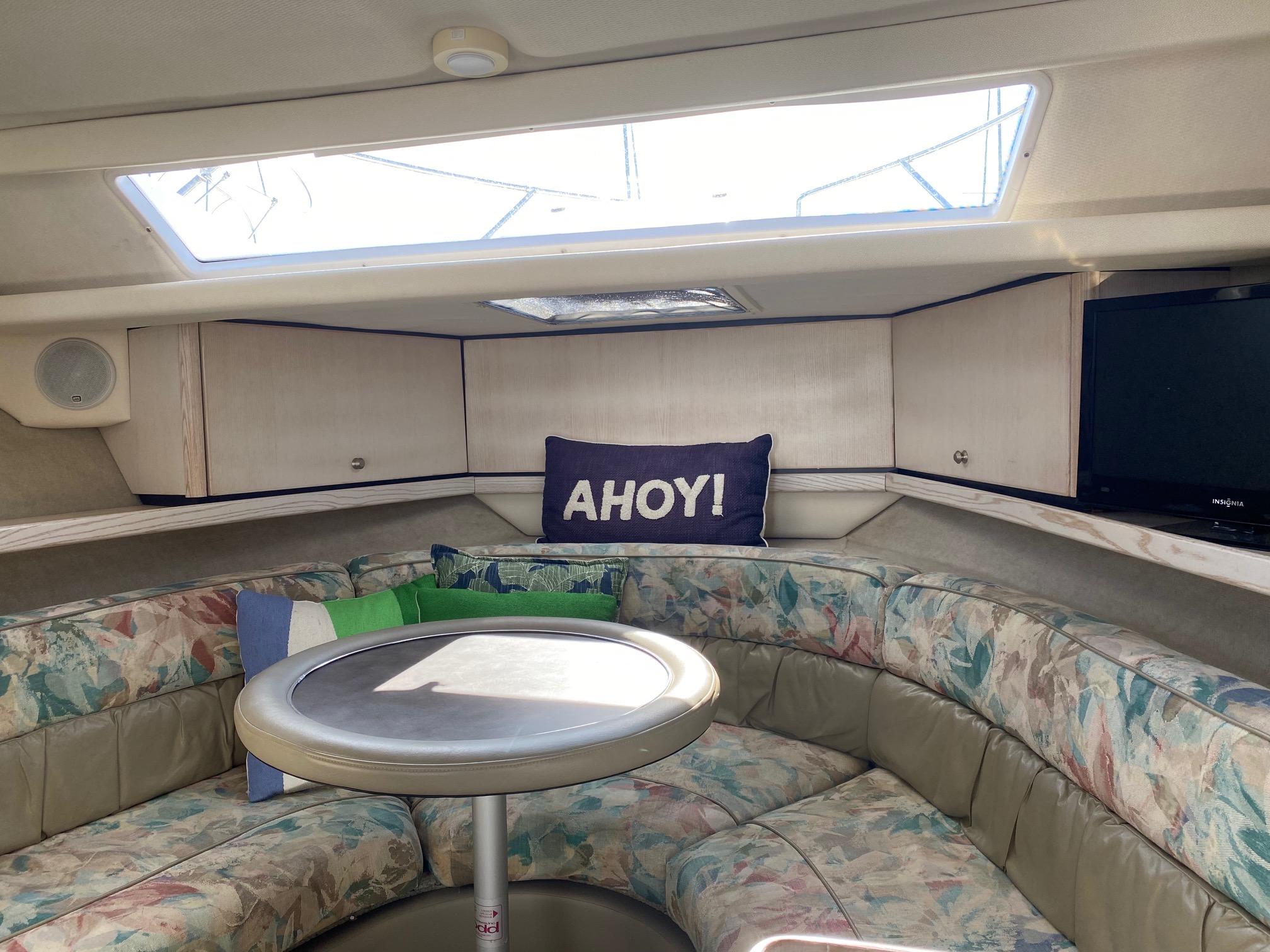 Slide: The Image of Interior of 1996 Bayliner 32 Avante boat with seating area and Ahoy! pillow. - 38