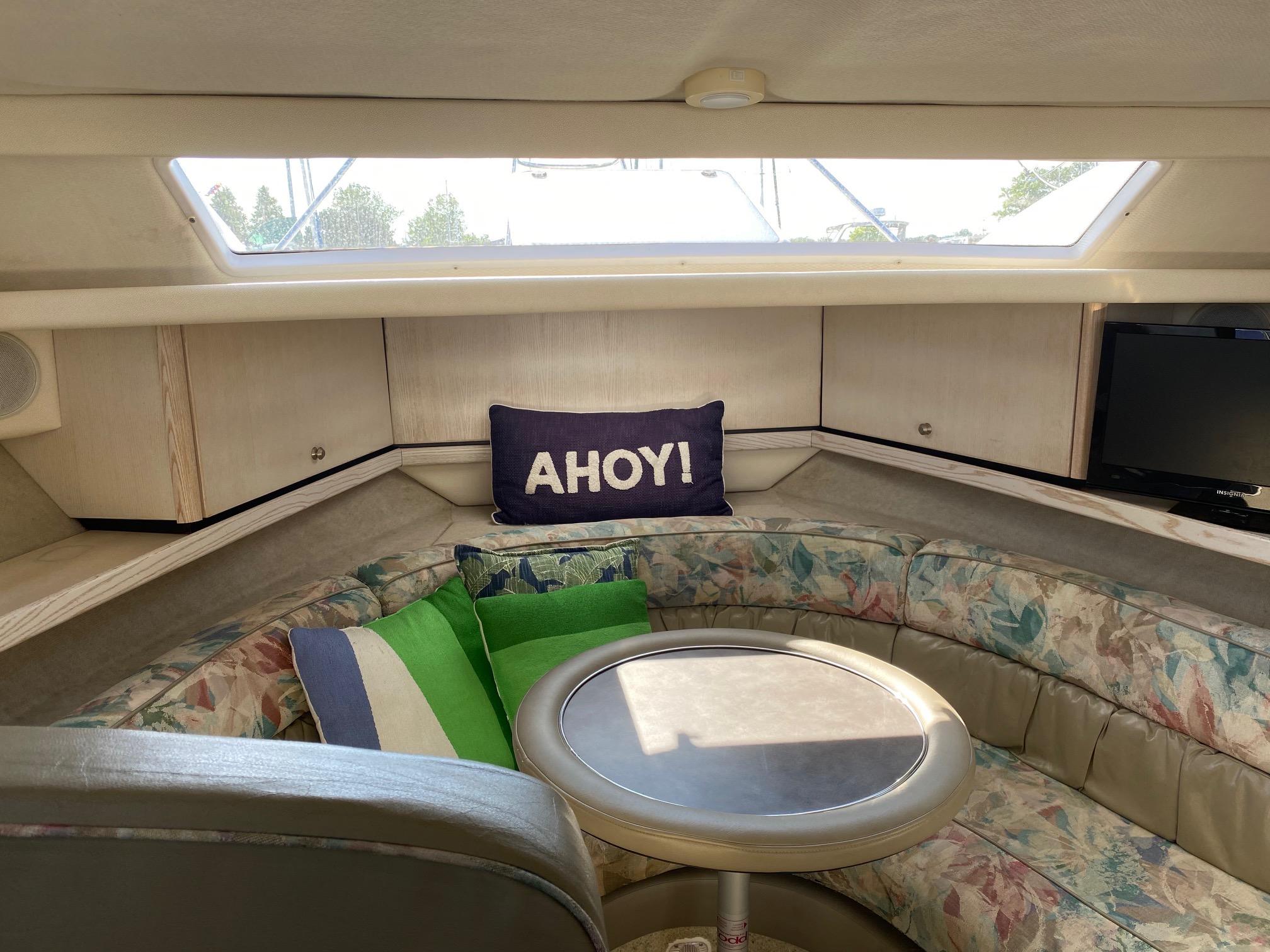Slide: The Image of Interior of 1996 Bayliner 32 Avante boat with cozy seating and Ahoy! pillow. - 39