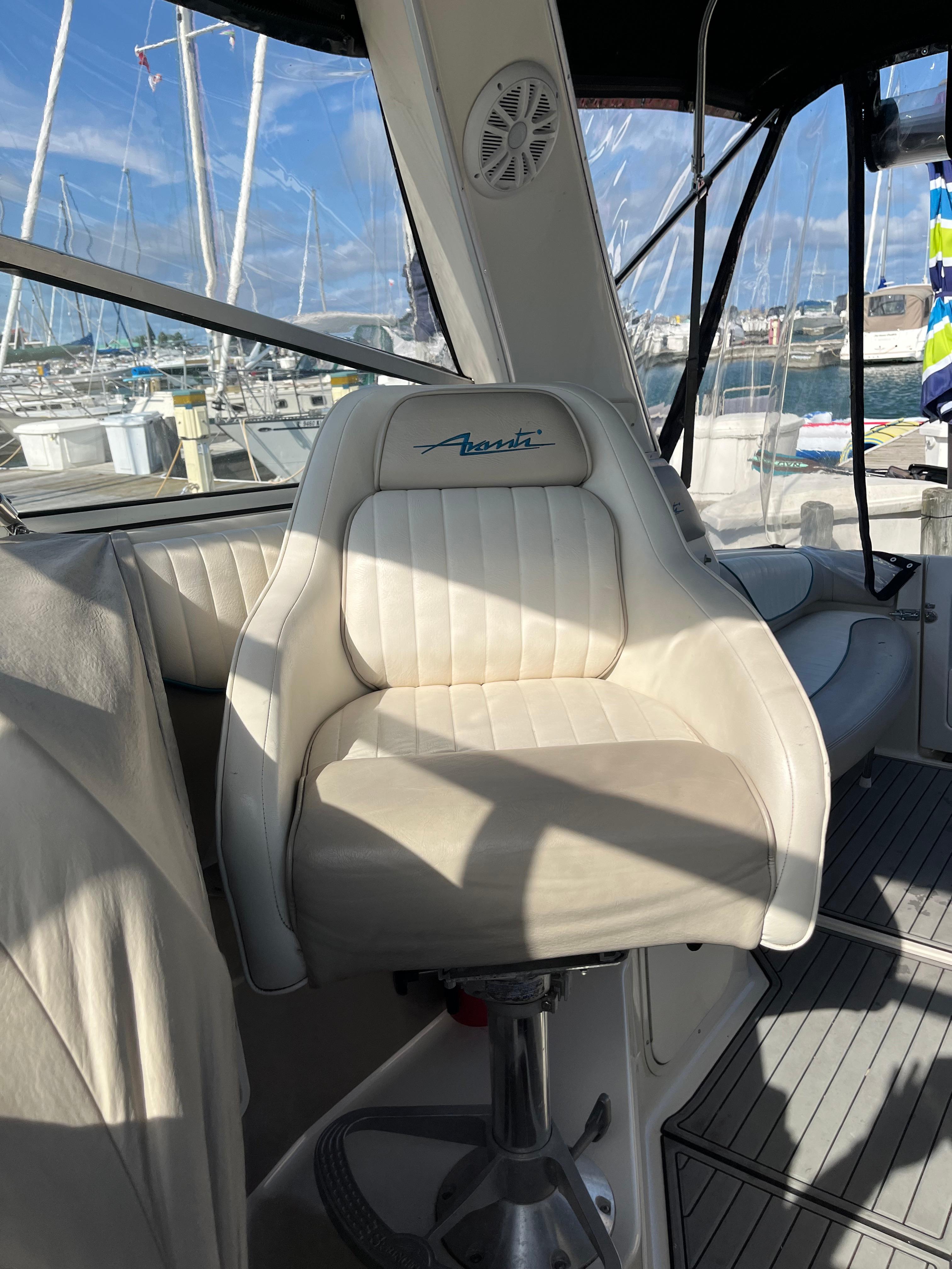 Slide: The Image of Captain's chair on a 1996 Bayliner 32 Avante boat, docked at a marina. - 4