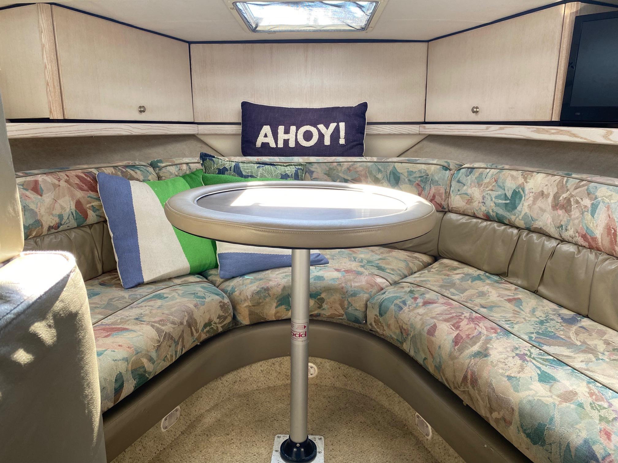 Slide: The Image of Interior of 1996 Bayliner 32 Avante boat with cozy seating and decorative pillows. - 40