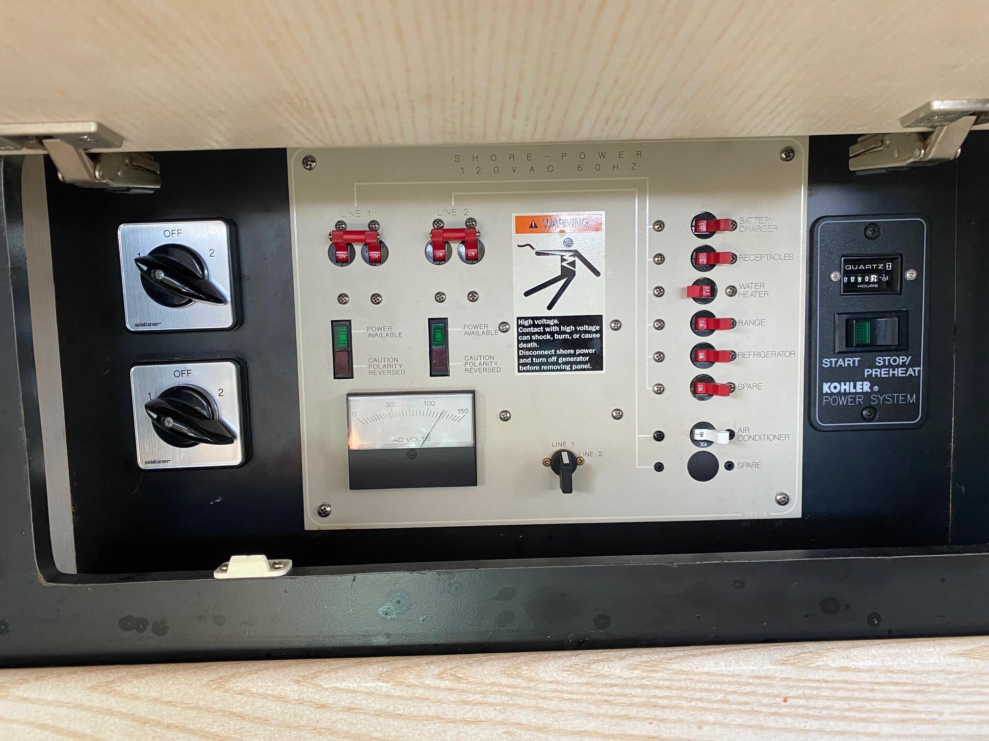 Slide: The Image of 1996 Bayliner 32 Avante control panel with switches and Kohler power system. - 45