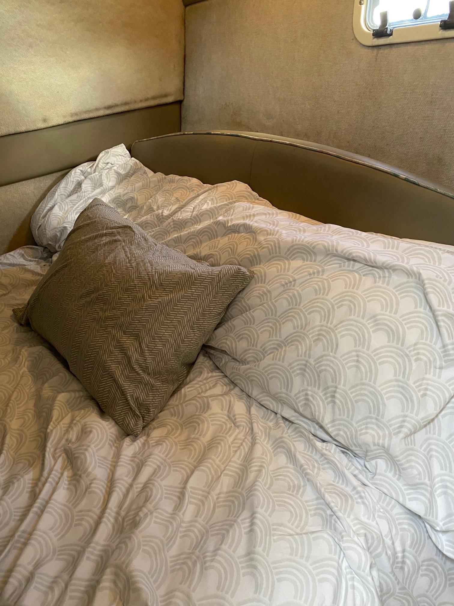 Slide: The Image of Cozy bed in the cabin of a 1996 Bayliner 32 Avante boat. - 48