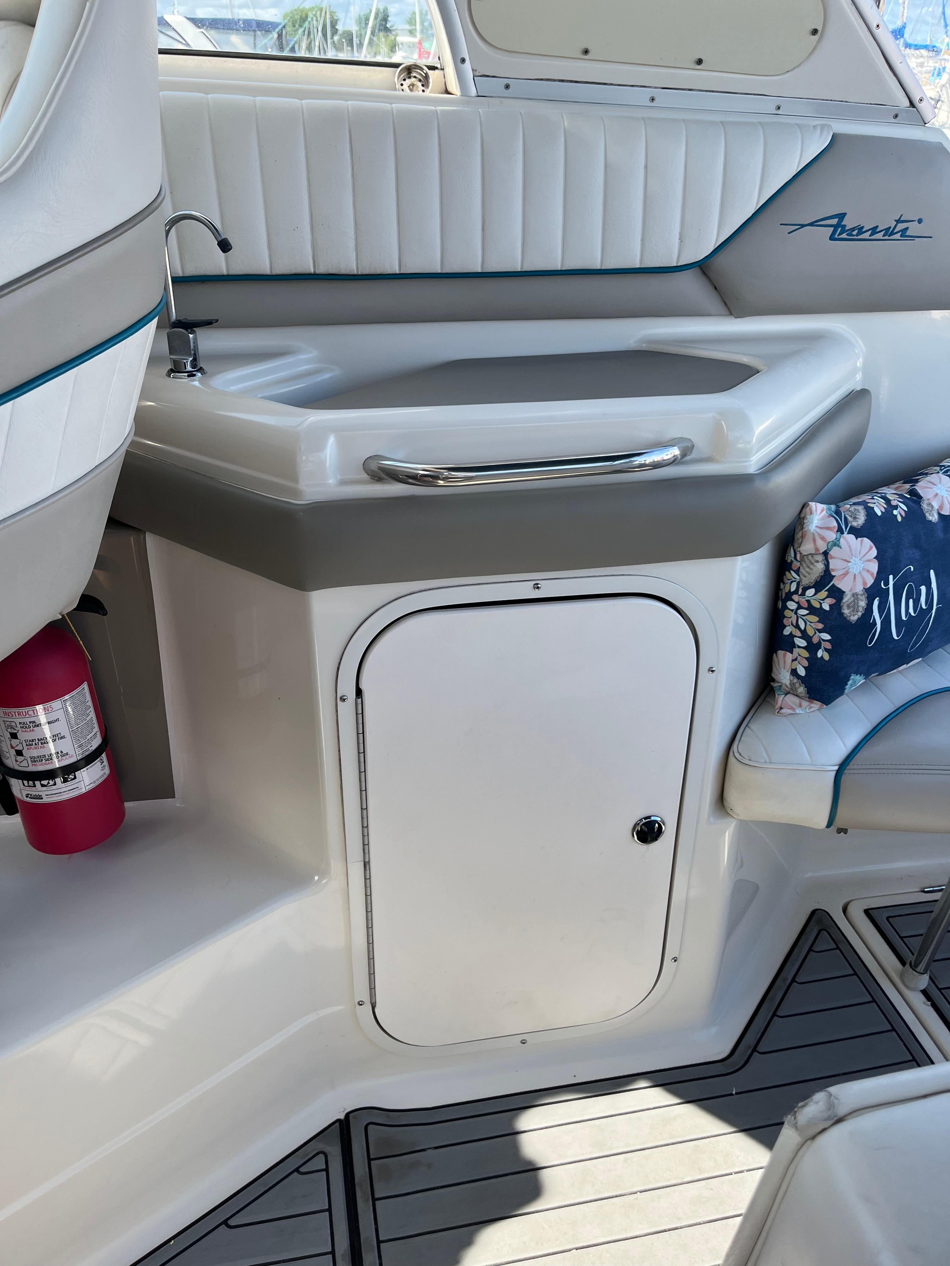 Slide: The Image of 1996 Bayliner 32 Avante boat interior with sink, storage, and seating. - 6