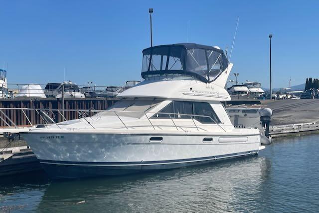 Slide: The Image of 2000 Bayliner 3388 motor yacht docked at a marina. - 0