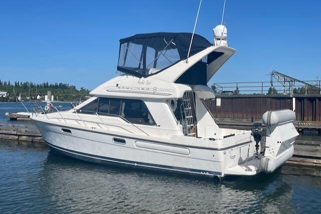 Slide: The Image of 2000 Bayliner 3388 motor yacht docked in a marina. - 1