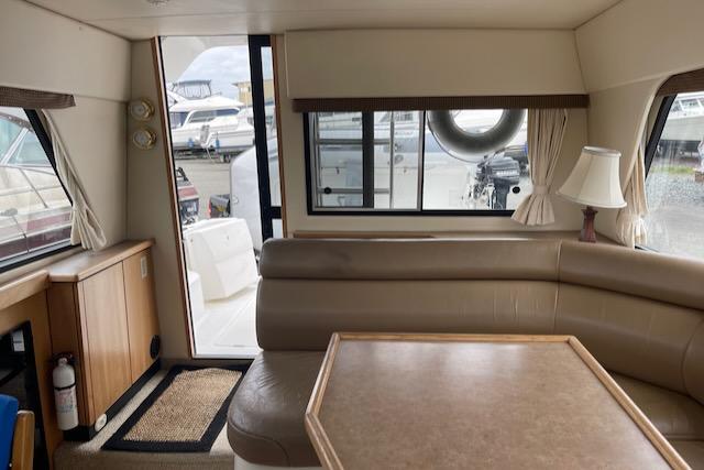 Slide: The Image of Interior of a 2000 Bayliner 3388 yacht with seating and table. - 11