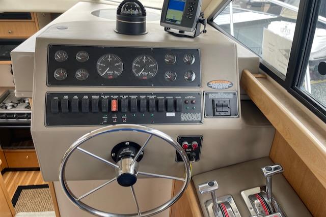 Slide: The Image of 2000 Bayliner 3388 boat helm with steering wheel, gauges, and controls. - 16