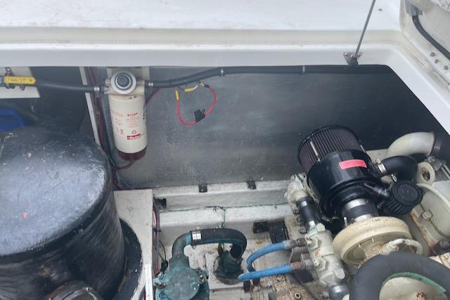 Slide: The Image of Engine compartment of a 2000 Bayliner 3388 boat showing various mechanical components. - 24