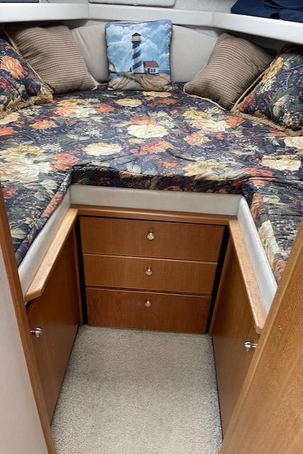 Slide: The Image of Bayliner 3388 2000 model cabin interior with floral bedding and lighthouse pillow. - 25