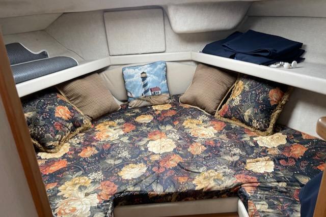Slide: The Image of Bayliner 3388 2000 model cabin with floral bedding and decorative pillows. - 26