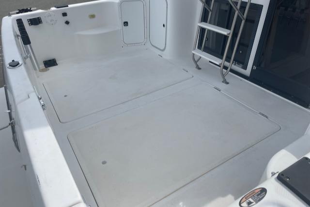 Slide: The Image of Bayliner 3388 2000 model boat deck with storage compartments and ladder. - 3