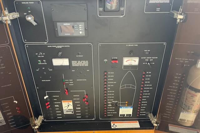 Slide: The Image of Control panel of a 2000 Bayliner 3388 boat with various switches and gauges. - 30