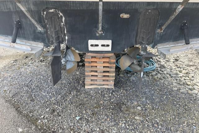 Slide: The Image of Bayliner 3388 2000 model boat propellers and rudders on dry dock. - 31
