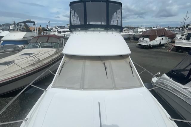 Slide: The Image of 2000 Bayliner 3388 yacht docked among other boats in a marina. - 32