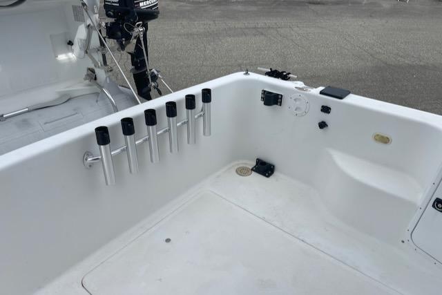 Slide: The Image of Bayliner 3388 2000 model boat deck with rod holders and outboard motor. - 37