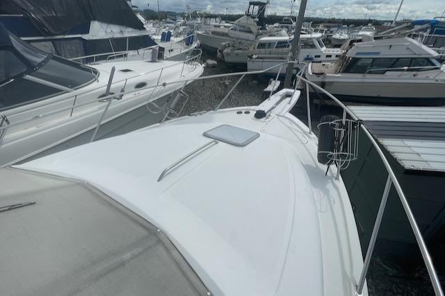Slide: The Image of 2000 Bayliner 3388 yacht docked among other boats at a marina. - 38