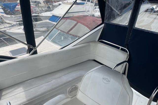 Slide: The Image of Bayliner 3388 2000 model boat interior with seating and marina view. - 5