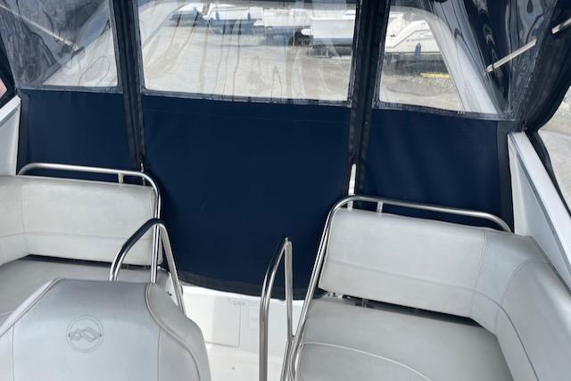 Slide: The Image of Interior seating area of a 2000 Bayliner 3388 boat with blue and white upholstery. - 7