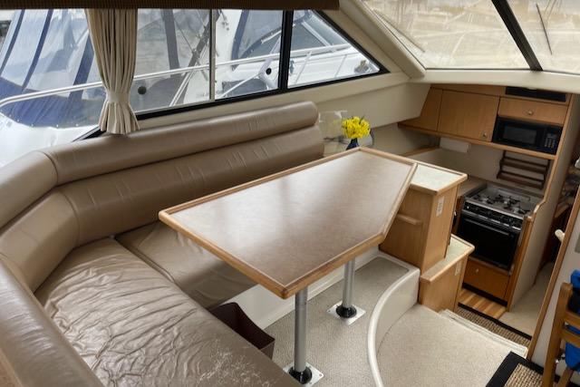 Slide: The Image of Interior of a 2000 Bayliner 3388 yacht with dining area and kitchen. - 9