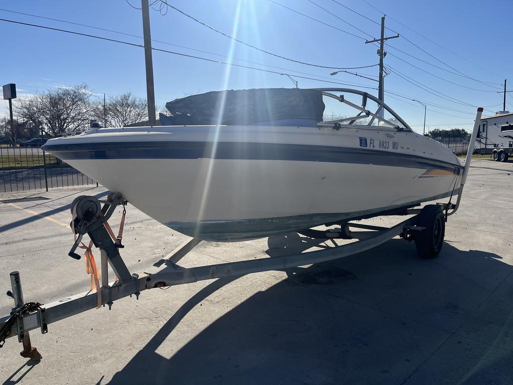 Slide: The Image of 2004 Bayliner 175 boat on a trailer in a sunny outdoor setting. - 12