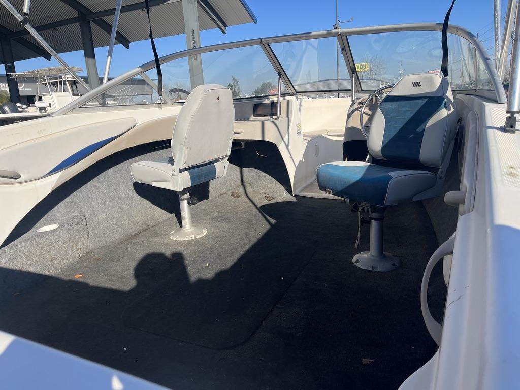 Slide: The Image of 2004 Bayliner 175 boat interior with two swivel seats and windshield. - 3