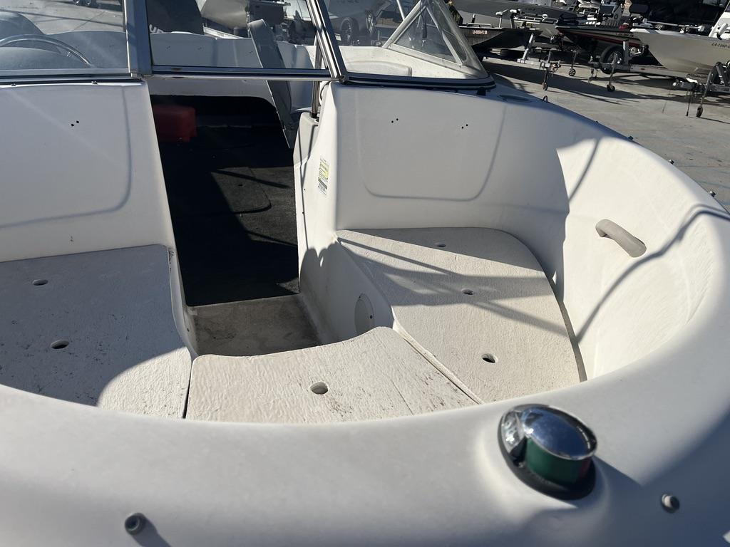 Slide: The Image of 2004 Bayliner 175 boat interior, showing bow seating area and windshield. - 9
