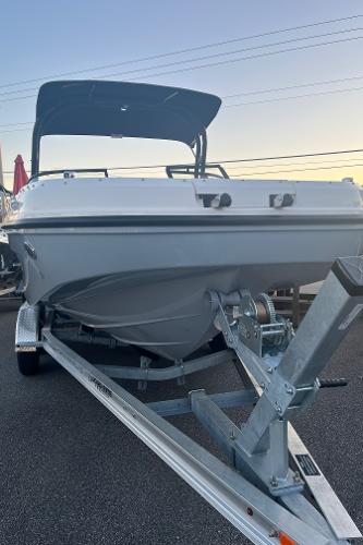 Slide: The Image of 2024 Bayliner DX2000 boat on a trailer at sunset. - 1