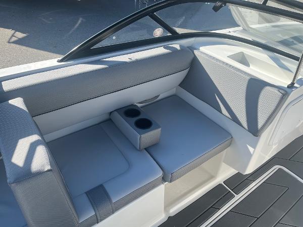 Slide: The Image of 2024 Bayliner DX2000 boat interior with gray seating and cup holders. - 10