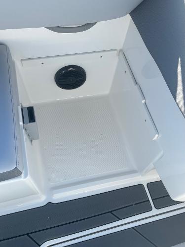 Slide: The Image of 2024 Bayliner DX2000 boat storage compartment with speaker. - 15