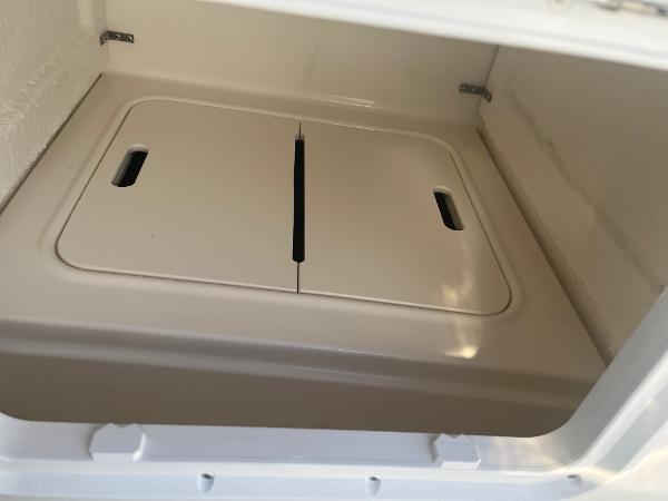 Slide: The Image of Storage compartment of 2024 Bayliner DX2000 boat with closed lid. - 16