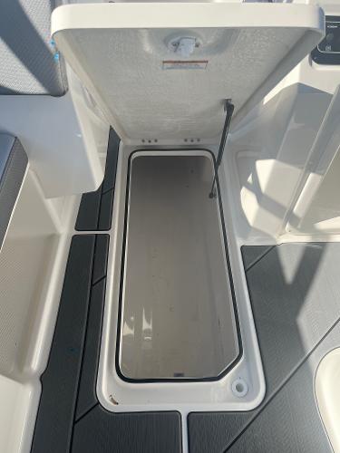 Slide: The Image of 2024 Bayliner DX2000 storage compartment with open hatch. - 17