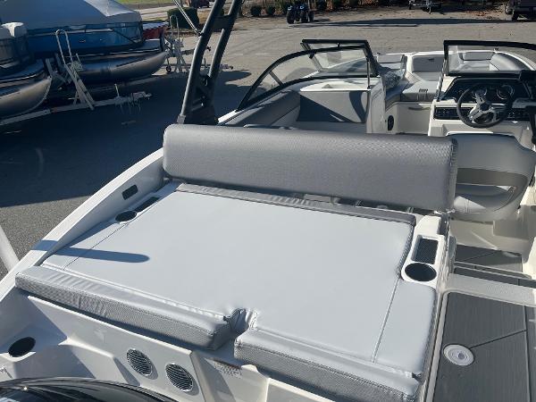 Slide: The Image of 2024 Bayliner DX2000 boat interior with gray seating and cup holders. - 18
