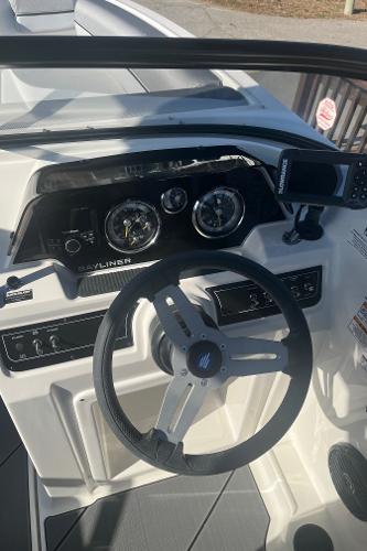 Slide: The Image of 2024 Bayliner DX2000 boat dashboard with steering wheel and instrument panel. - 19