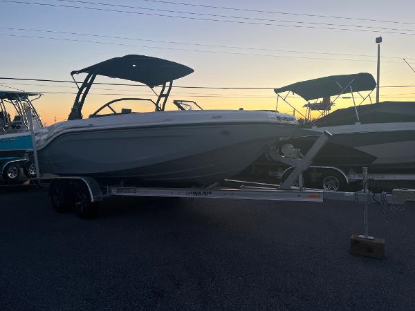 Slide: The Image of 2024 Bayliner DX2000 boat on trailer at sunset. - 2