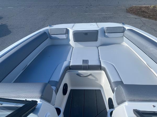 Slide: The Image of 2024 Bayliner DX2000 boat interior with cushioned seating and storage compartments. - 4