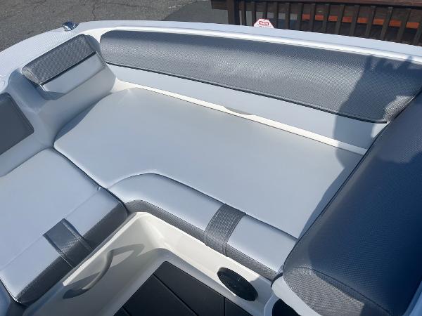 Slide: The Image of 2024 Bayliner DX2000 boat interior seating area with gray and white upholstery. - 5