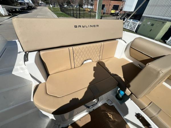 Slide: The Image of 2023 Bayliner DX 2050 boat with tan leather seating and Bayliner branding. - 10