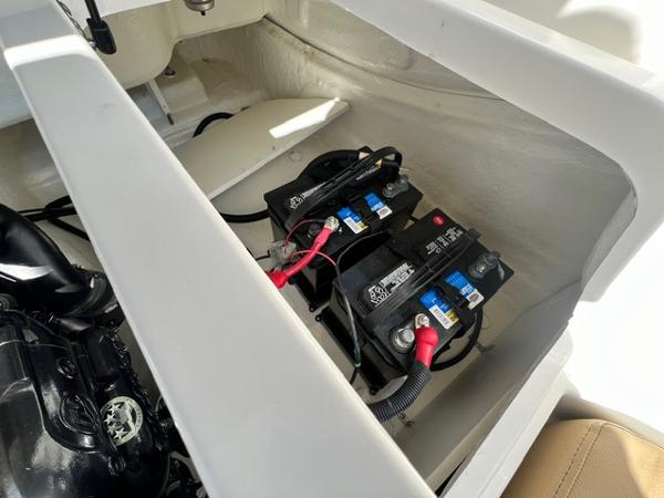 Slide: The Image of 2023 Bayliner DX 2050 boat battery compartment with dual batteries. - 13