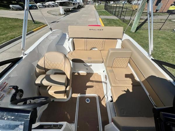 Slide: The Image of 2023 Bayliner DX 2050 boat interior with tan seating and steering console. - 9