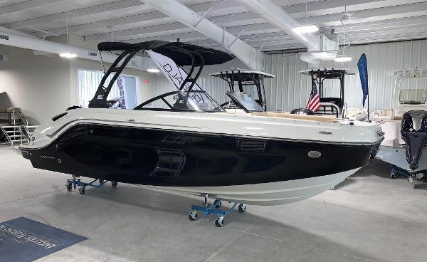 Slide: The Image of 2024 Bayliner DX2200 boat displayed in a showroom. - 0
