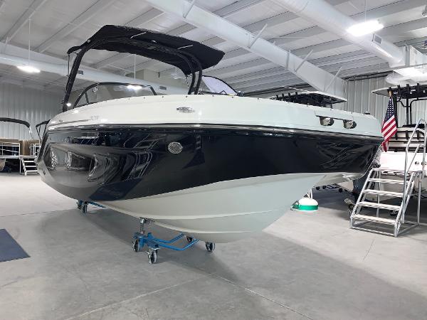 Slide: The Image of 2024 Bayliner DX2200 boat displayed in a showroom. - 3