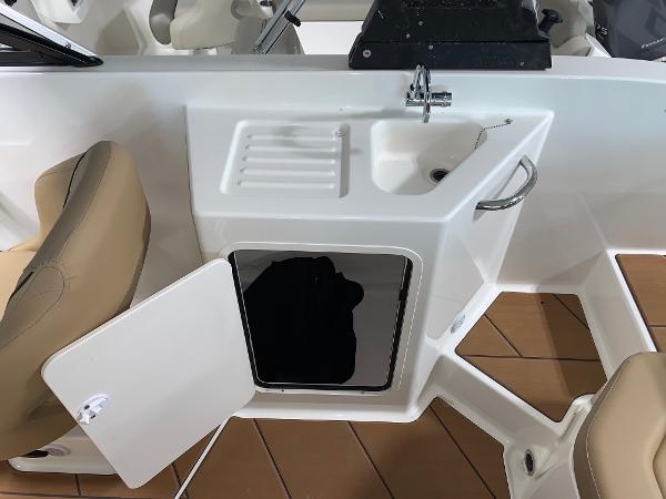 Slide: The Image of Bayliner DX2200 2024 boat interior with sink and storage compartment. - 5