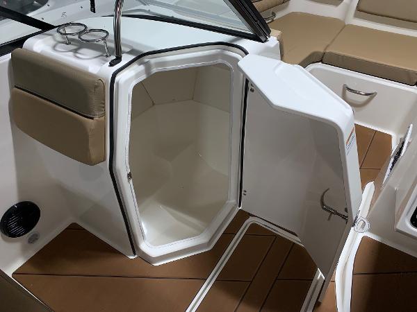 Slide: The Image of 2024 Bayliner DX2200 boat interior with open storage compartment. - 6