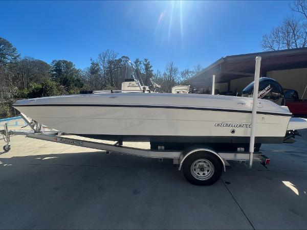 Slide: The Image of 2021 Bayliner E21 boat on trailer in outdoor setting. - 1